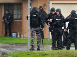 Sacramento Police SWAT team members gather near a crime scene where a Sacramento Animal Control officer was fatally shot through the door of a residence in Galt, Calif. on Nov. 28. Sacramento Police SWAT team members gather near a crime scene where a Sacramento Animal Control officer was fatally shot through the door of a residence in Galt, Calif. on Nov. 28.
