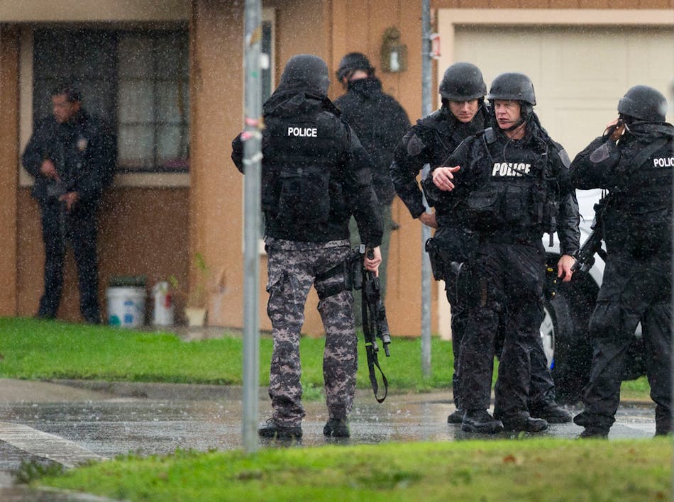 Sacramento Police SWAT team members gather near a crime scene where a Sacramento Animal Control officer was fatally shot through the door of a residence in Galt, Calif. on Nov. 28.