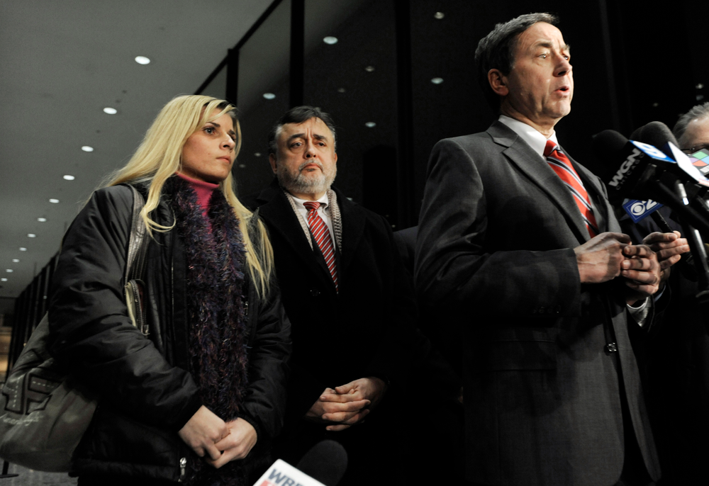 Bartender Karolina Obrycka, left, listens while her attorney Terry Ekl, right, speaks during a news conference in Chicago on Nov. 13.