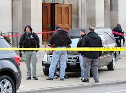 Chicago police investigate a shooting of two men outside St. Columbanus Church in Chicago on Nov. 26. Chicago police investigate a shooting of two men outside St. Columbanus Church in Chicago on Nov. 26.