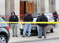 Chicago police investigate a shooting of two men outside St. Columbanus Church in Chicago on Nov. 26.