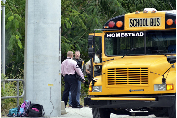Police investigate the scene of a shooting on a school bus in Homestead, Fla., near Miami, Tuesday, Nov. 20, 2012.