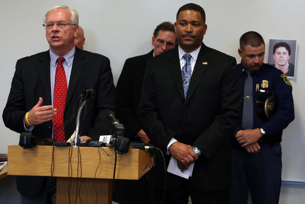 Law enforcement officers and prosecutors tell the media about the arrest of the interstate shooter.