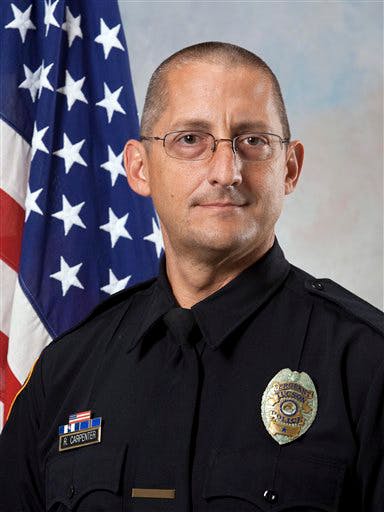 This undated photo released by the Tucson, Ariz., police department shows Sgt. Robert Carpenter. Carpenter was recovering Sunday, Nov. 18, 2012, following surgery after he was shot in the head while checking on a home where a break-in had been reported, authorities said. The assailant remained on the loose. Carpenter was standing with other officers near the home just before dawn Sunday when they heard a loud noise, and he fell, Chief Roberto Villasenor said. He underwent surgery and was able to speak afterward.