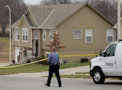 A police officer walks to an Independence, Mo., house house where police say Kansas City Chiefs linebacker Jovan Belcher fatally shot his girlfriend before driving to the NFL football team&apos;&apos;s training facility and shooting himself.