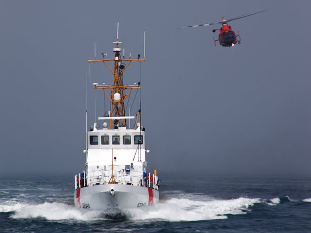 A Rescue Helicopter from Airs Station Los Angeles conducts a close fly-by of the Coast Guard Cutter Halibut.