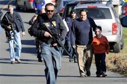 Parents leave a staging area after being reunited with their children following a shooting at the Sandy Hook Elementary School in Newtown, Conn. on Dec. 14. Parents leave a staging area after being reunited with their children following a shooting at the Sandy Hook Elementary School in Newtown, Conn. on Dec. 14.