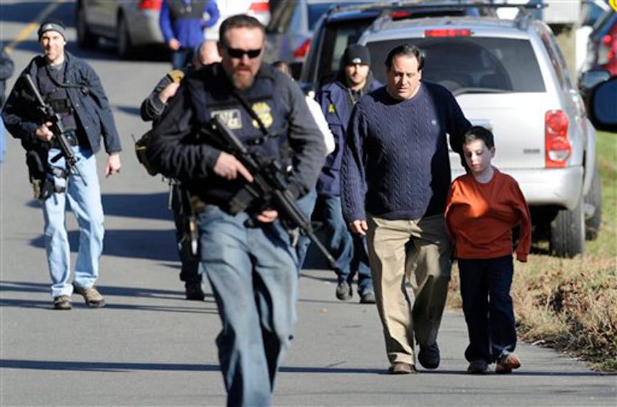 Parents leave a staging area after being reunited with their children following a shooting at the Sandy Hook Elementary School in Newtown, Conn. on Dec. 14.