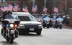 A motorcade of Illinois State Police motorcycle officers escort the funeral hearse carrying the remains of Trooper Kyle Deatherage after a service in Troy, Ill. on Dec. 1.