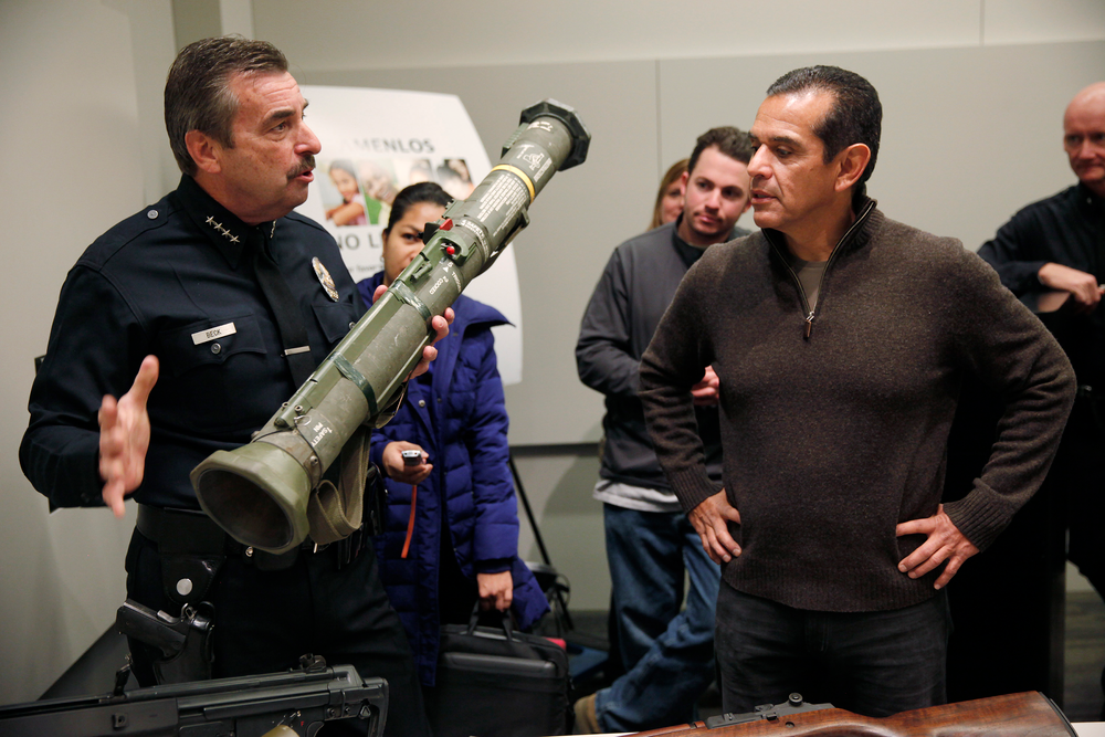 LAPD Chief Charlie Beck, left, shows off one of two rocket launchers turned in during the city's latest gun buyback program.