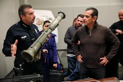 LAPD Chief Charlie Beck, left, shows off one of two rocket launchers turned in during the city&apos;s latest gun buyback program.