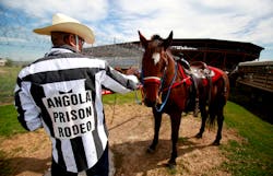 Inmate Danny Young pets his horse before participating in the Angola Prison Rodeo at the Louisiana State Penitentiary on Oct. 21 in Angola, La. Inmate Danny Young pets his horse before participating in the Angola Prison Rodeo at the Louisiana State Penitentiary on Oct. 21 in Angola, La.