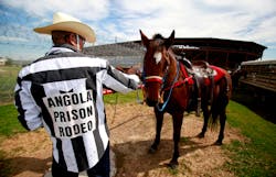 Inmate Danny Young pets his horse before participating in the Angola Prison Rodeo at the Louisiana State Penitentiary on Oct. 21 in Angola, La.