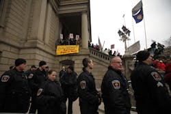 Police from Lansing are on standby as the protest against right-to-work legislation continues outside the Michigan State Capitol on Dec. 11. Police from Lansing are on standby as the protest against right-to-work legislation continues outside the Michigan State Capitol on Dec. 11.