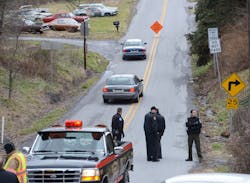 Local law enforcement block off road along Rt. 22 near the Canoe Creek State Park, Pa. while investigating a shooting on Dec. 21.