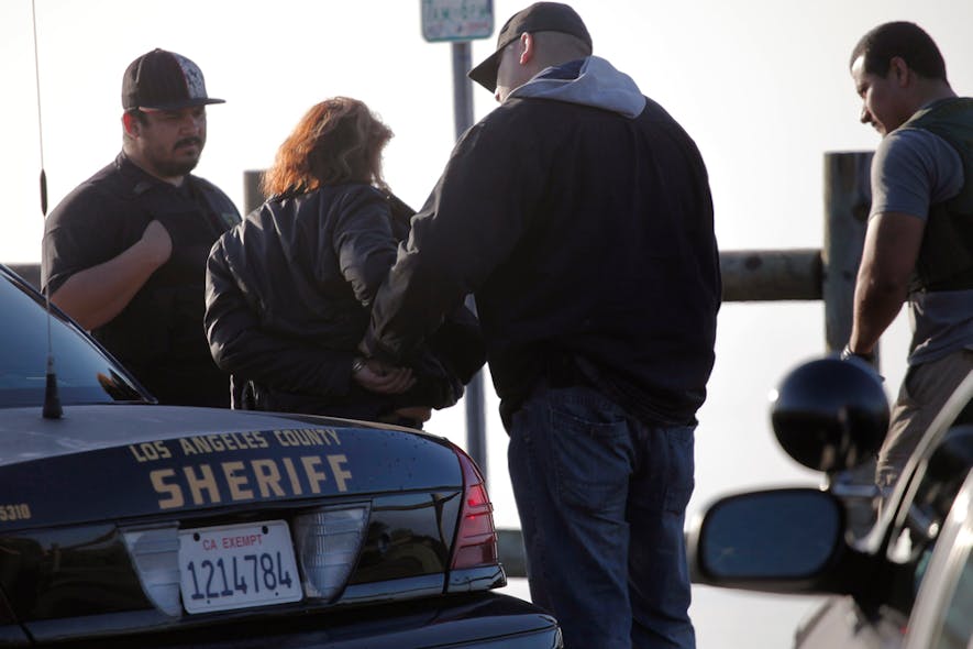 A person is detained in Rancho Palos Verdes, Calif. on Dec. 10 as law enforcement personnel stopped several people that were believed to be illegal immigrants.