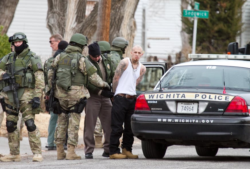 The Wichita Police SWAT team converge on a house in the 2400 block of Newell, near Meridian and Central on Jan. 9.