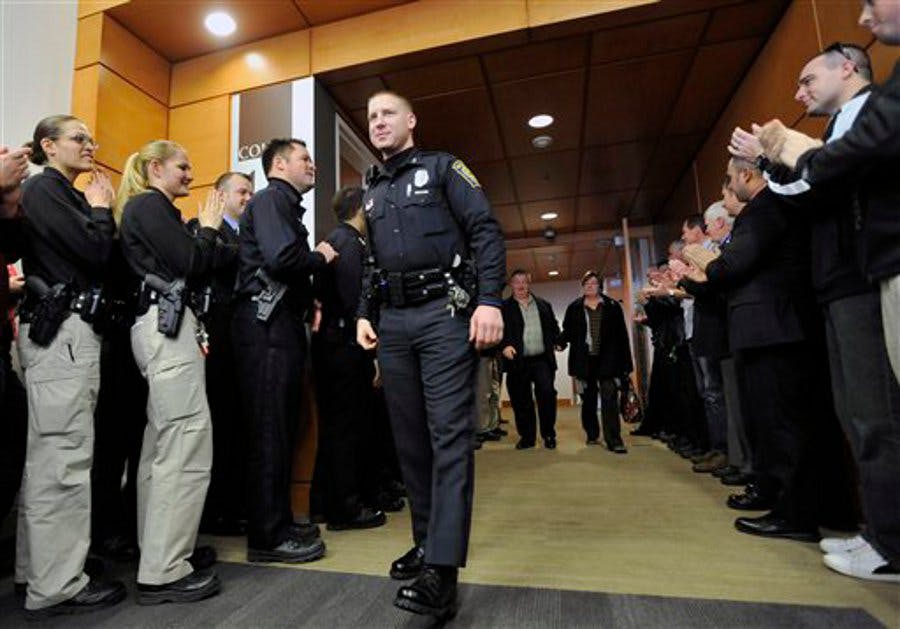 Manchester Police Officer Daniel Doherty walks through a gauntlet of police officers after a judge sentenced Myles Webster to 60 years to life in jail on Jan. 14.