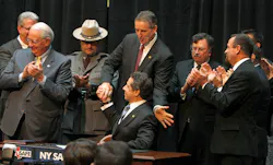 New York Gov. Andrew Cuomo, seated at center, gets a congratulatory hand shake from Lt. Gov. Robert Duffy after signing the NY Safe Act on Jan. 16. New York Gov. Andrew Cuomo, seated at center, gets a congratulatory hand shake from Lt. Gov. Robert Duffy after signing the NY Safe Act on Jan. 16.