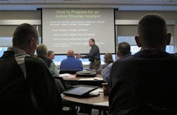 Instructor James Burke, front center, of the Ohio Peace Officer Training Academy speaks at an event to train educators and law enforcement officers about school shooting responses in Columbus, Ohio on Jan. 17.