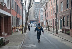 A Philadelphia Police crime scene unit officer walks down street where a woman was found burned to death in her basement in Philadelphia on Jan. 21. A Philadelphia Police crime scene unit officer walks down street where a woman was found burned to death in her basement in Philadelphia on Jan. 21.