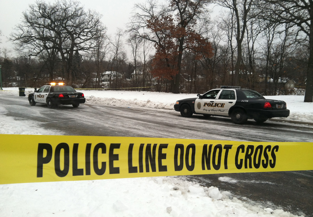 Police search the area near where an armed suspect robbed the Kowalski on Grand market and was later shot by St. Paul officers on Dec. 17, 2012.