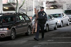 Seattle Police Sgt. Paul Gracy carries guns collected from people in a City of Seattle drive-thru gun exchange program on Jan. 26. Seattle Police Sgt. Paul Gracy carries guns collected from people in a City of Seattle drive-thru gun exchange program on Jan. 26.