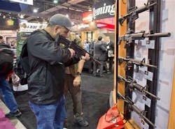 Stuart Konicar looks down the sight of a Remington Adaptive Combat Rifle on display at the Remington Defense exhibit during the SHOT Show on Jan. 15 in Las Vegas. Stuart Konicar looks down the sight of a Remington Adaptive Combat Rifle on display at the Remington Defense exhibit during the SHOT Show on Jan. 15 in Las Vegas.