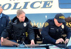 Tucson police officers catalog a gun outside a police station during a gun buyback program on Jan. 8.