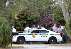 Miami-Dade police investigate a crime scene at the Lakes of the Meadow development in West Kendall, Fla. on Feb. 20.