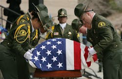 A San Bernardino County Sheriffs Honor Guard folds the flag draped over the casket of Deputy Jeremiah MacKay during his funeral service on Feb. 21. A San Bernardino County Sheriffs Honor Guard folds the flag draped over the casket of Deputy Jeremiah MacKay during his funeral service on Feb. 21.