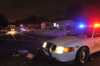 A police car sits at a roped off area at Seventh Street and Hadley Avenue in Oakdale, Minn. on Feb. 11.