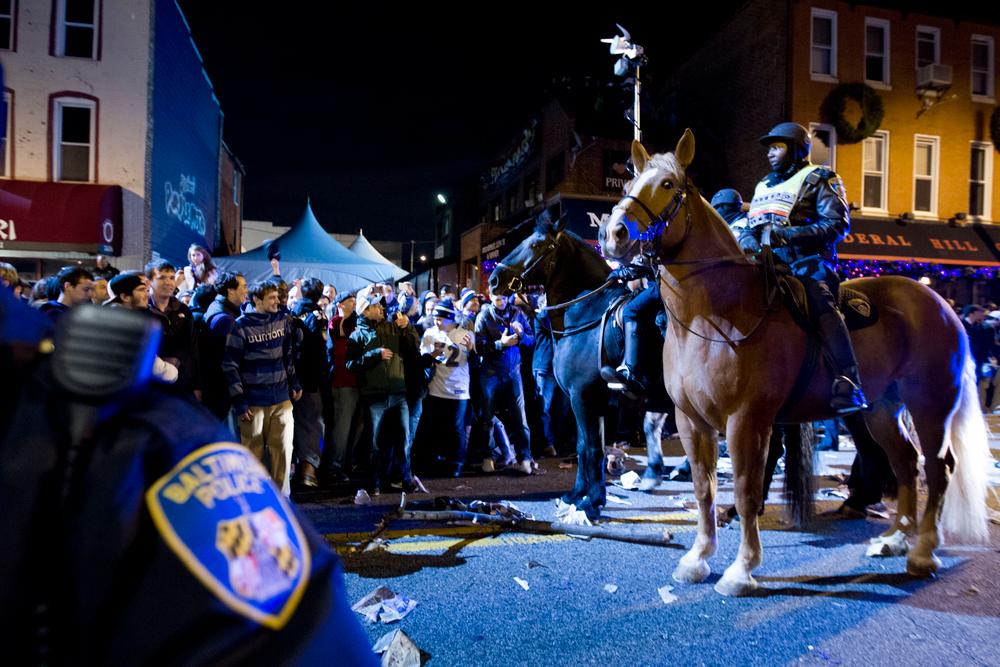 Officers push back Baltimore Ravens fans celebrating in the streets in downtown Baltimore after their team won the Super Bowl on Feb. 3.