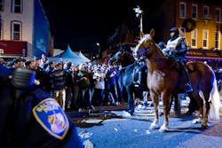 Officers push back Baltimore Ravens fans celebrating in the streets in downtown Baltimore after their team won the Super Bowl on Feb. 3. Officers push back Baltimore Ravens fans celebrating in the streets in downtown Baltimore after their team won the Super Bowl on Feb. 3.