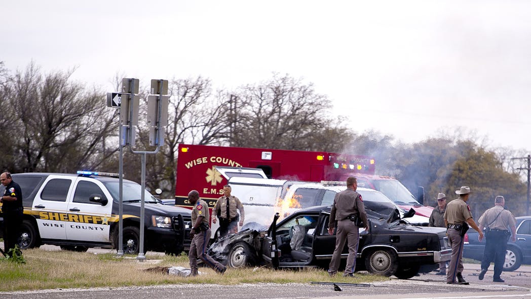 Emergency personnel are on the scene of a crash and shootout with police involving the driver of a black Cadillac with Colorado plates in Decatur, Texas on March 21.