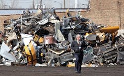 Chicago Police Commander Eugene Roy, Area Central Detectives, walks past a pile of bus remnants at SRV Metal Scrapper on March 8.
