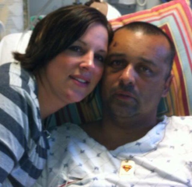 Alexandria Police Officer Peter Laboy is seen with his wife Suzi inside his hospital room.