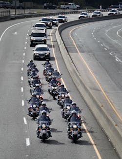 A procession of police officers from supporting agencies, coming from Santa Cruz heads north on Hwy 17 near Bear Creek Road on their way to HP Pavilion in San Jose, Calif. on March 7.