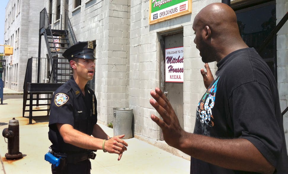 NYPD Det. Anthony Mannuzza, left, and Police Officer Robert Martin, right, simulate a street stop during a training session at a training facility.