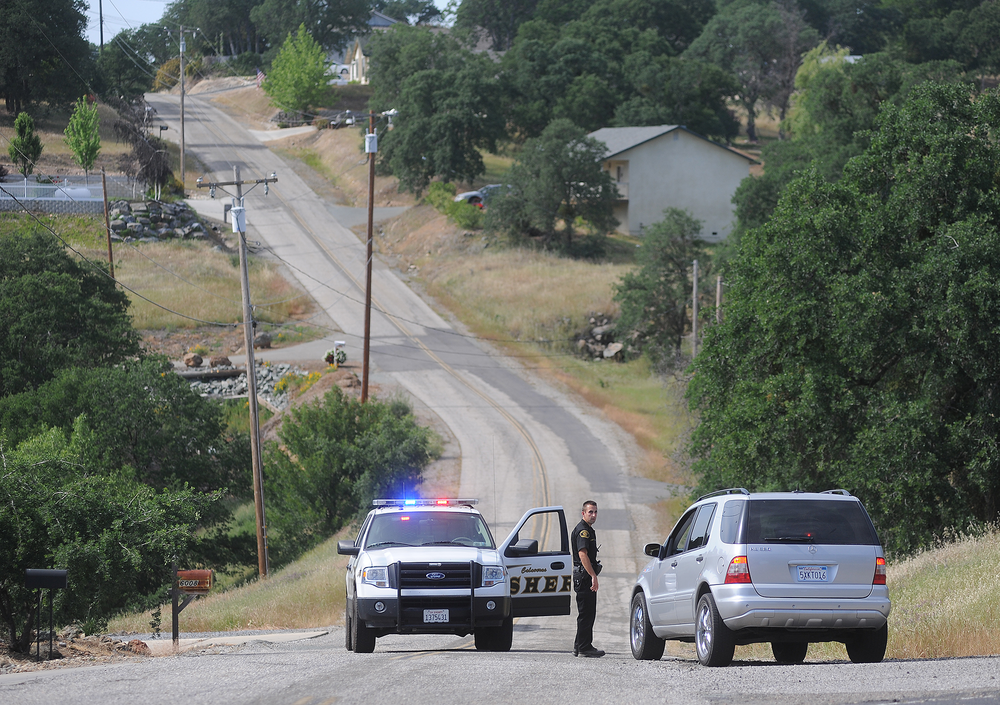 A Calaveras County Sheriff's deputy detains a driver on Rippon Rd. in Valley Springs, Calif., where 8-year-old Leila Fowler was found murdered.
