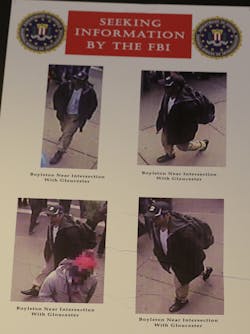 Photos of one of two suspects sought in the Boston Marathon bombing is displayed during a news conference talking about the investigation of the Boston Marathon explosions on April 18.