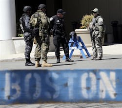 Officials in tactical gear stand guard behind a Boston Police Department barricade near the site of the Boston Marathon explosions on April 17. Officials in tactical gear stand guard behind a Boston Police Department barricade near the site of the Boston Marathon explosions on April 17.