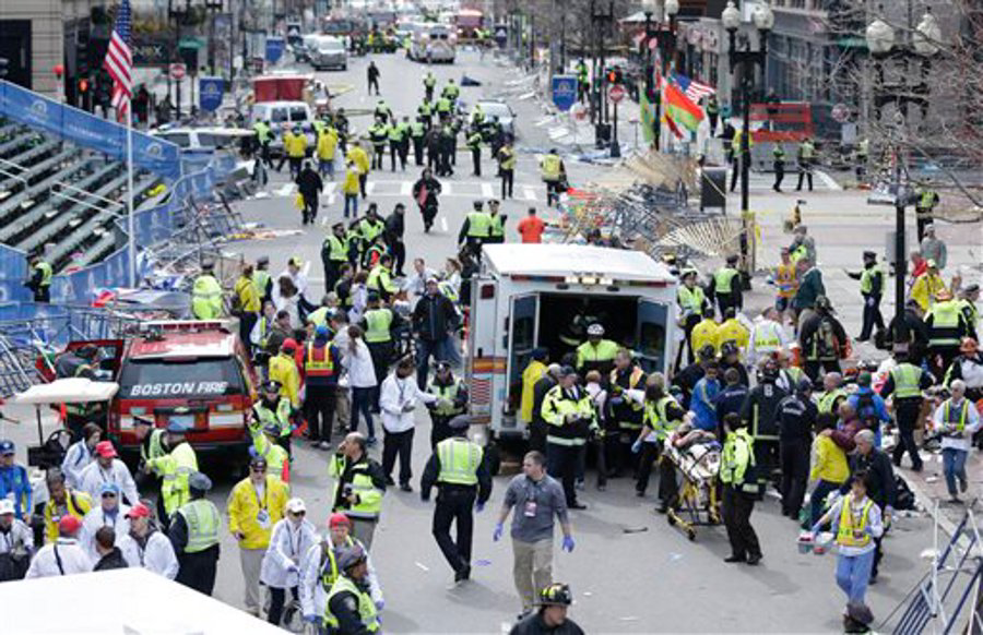 Medical workers aid injured people at the finish line of the 2013 Boston Marathon following an explosion in Boston.