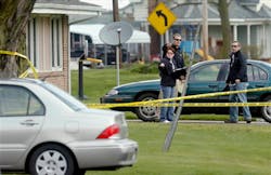 Police officials investigate the scene at a house in Manchester, Ill. on April 24. Police officials investigate the scene at a house in Manchester, Ill. on April 24.