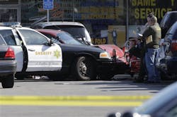 Los Angeles County Sheriff investigators view the scene of a confrontation between a deputy and a civilian at a strip mall in the unincorporated Athens area of South Los Angeles on April 26.