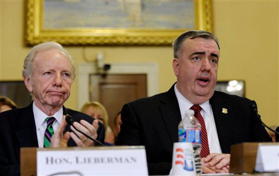 Boston Police Commissioner Edward Davis is applauded by former Sen. Joesph Lieberman, I-Conn., as he is introduced before testifying at the House Homeland Security Committee hearing on 'The Boston Bombings: A First Look,' on Capitol Hill in Washington, D.C. on May 9.