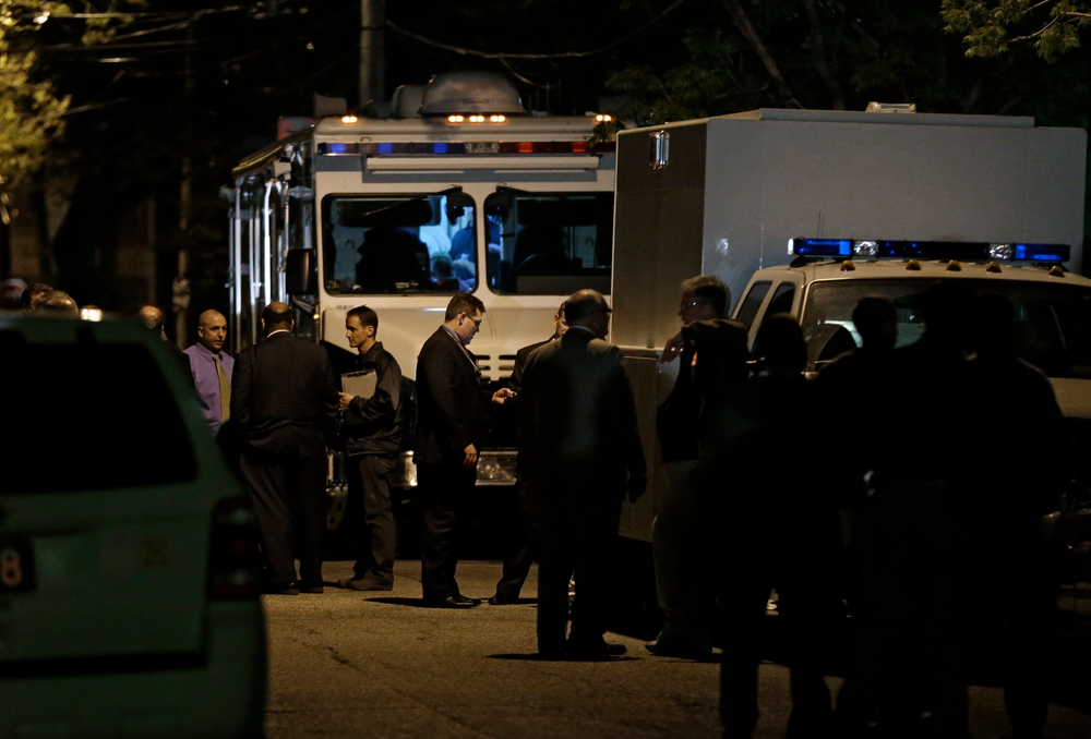 Police and FBI congregate outside a house on Cleveland's west side on May 6 where police say three women were found.
