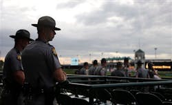 Kentucky State Police watch the race track during morning workouts at Churchill Downs on May 3 in Louisville, Ky. Kentucky State Police watch the race track during morning workouts at Churchill Downs on May 3 in Louisville, Ky.