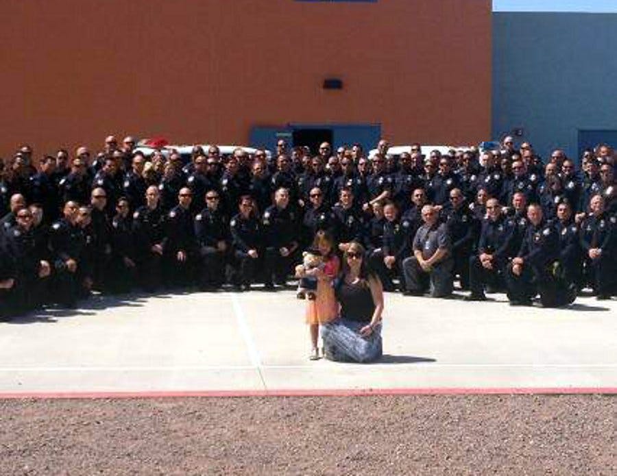Tatum Raetz, the daughter of fallen Phoenix Officer Daryl Raetz, was joined by close to 100 officers at her kindergarten graduation on May 22.