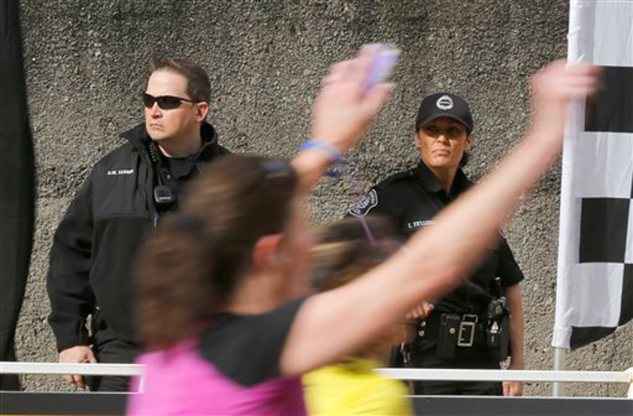Pittsburgh Police stand guard as runners head to the finish of the Pittsburgh Marathon on May 5.